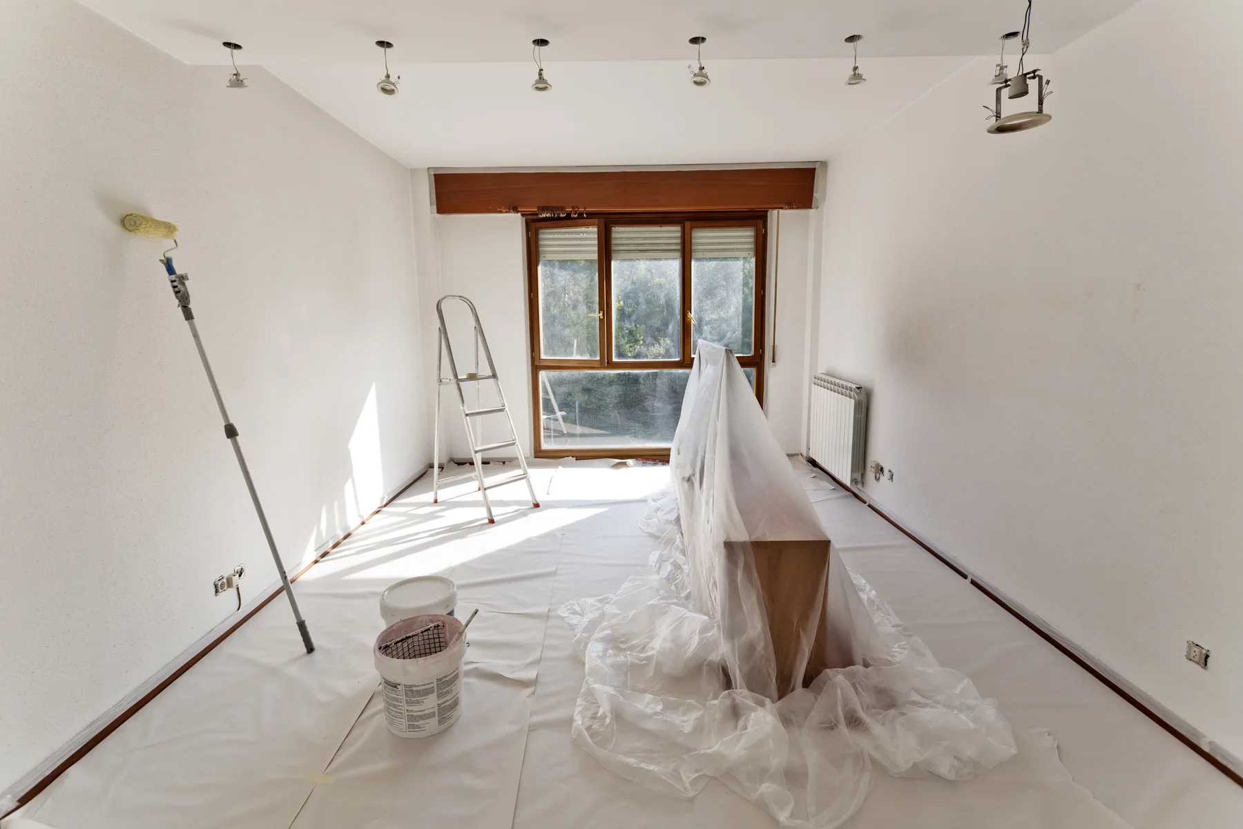 Bright interior carefully protected and prepared for painting