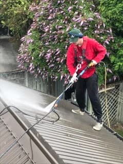 Painter preparing a long-run metal roof